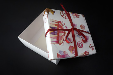 Stylish paper box, tied a satin ribbon closeup.