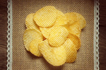 Crispy potato chips on a tablecloth