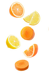 Falling orange, limon and carrot isolated on white