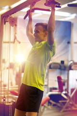 Fototapeta na wymiar smiling man exercising in gym