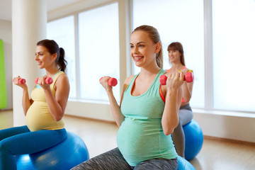 pregnant women training with exercise balls in gym