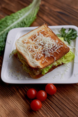 A delicious sandwich with salad and chicken. Sprinkled with cheese. A quick delicious Breakfast