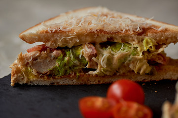 A delicious sandwich with salad and chicken. Sprinkled with cheese. A quick delicious Breakfast
