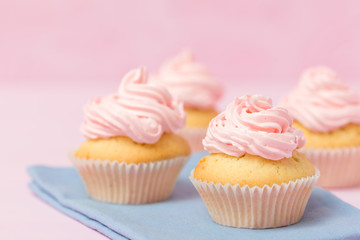 Cupcake decorated with pink buttercream on pastel pink background. Sweet beautiful cake. Horizontal banner, greeting card for birthday, wedding, women's day. Close up photography. Selective focus