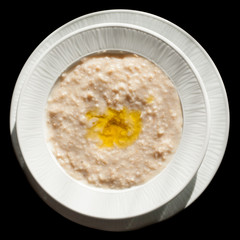 Oatmeal with olive oil isolated on black