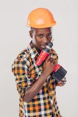 African American worker uses electric screwdriver