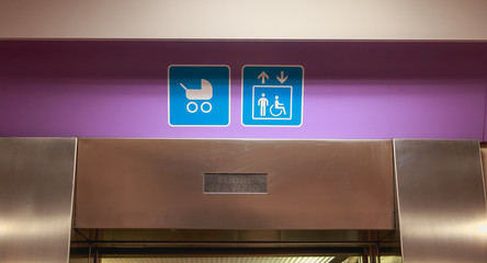 access for stroller and disabled sign over a lift door