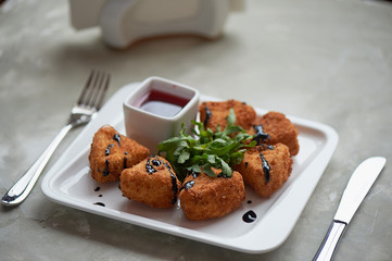 Camembert in batter, deep fried, with balsamic vinegar and arugula
