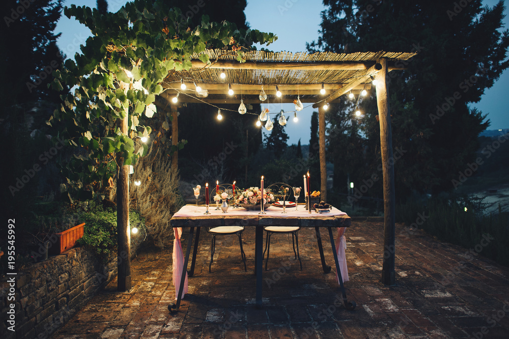 Wall mural decorated outdoor wedding table with flowers in rustic style