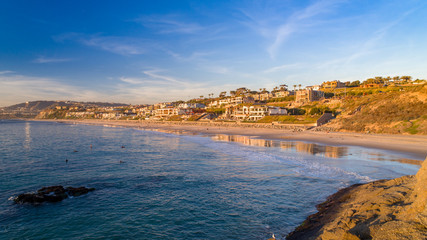 California coast in Orange County on a sunny afternoon with the beach and houses in view.