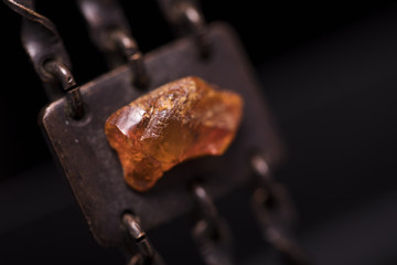Part of a metal and amber necklace