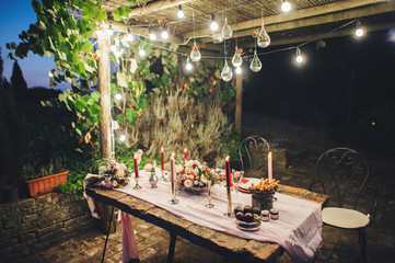 Decorated outdoor wedding table with flowers in rustic style