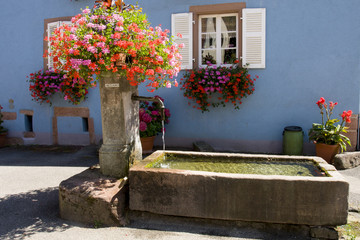 Fountain in a typical village of Alsace France.