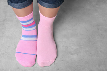 Woman in different socks indoors