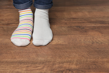 Woman in different socks indoors