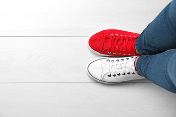 Woman in different sneakers indoors