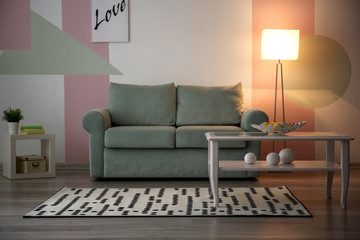Stylish living room interior with table and comfortable sofa