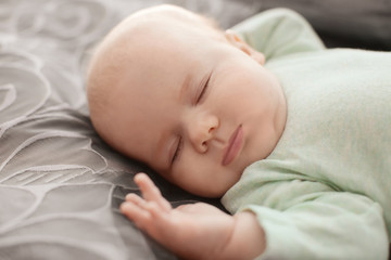 Cute little baby sleeping on bed