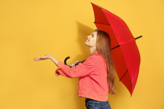 Young Woman With Red Umbrella On Color Background