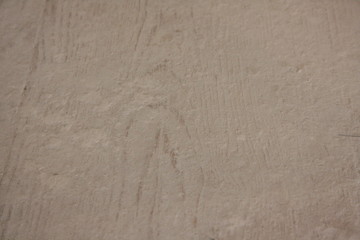 Pale plastered wall texture background in black and white with vignette