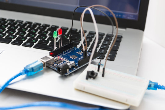 A metal robot and an electronic board that can be programmed. Robotics and electronics. A robot assembly builder. Laboratory in the school. Mathematics, engineering, science.