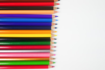 Color pencils placed horizontally on a white background