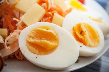closeup of hard boiled eggs with vegetables in a plate