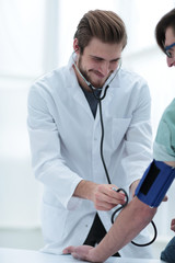 Physician measuring blood pressure to make a diagnosis