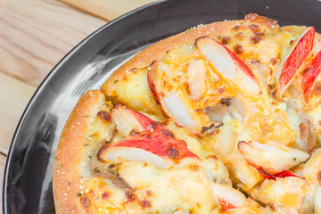 Pizza be appetizing on wooden background.