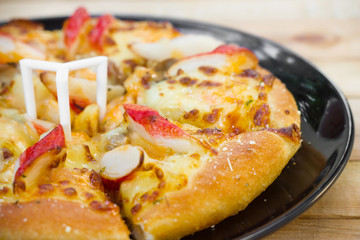 Pizza be appetizing on wooden background.