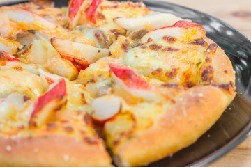 Pizza be appetizing on wooden background.