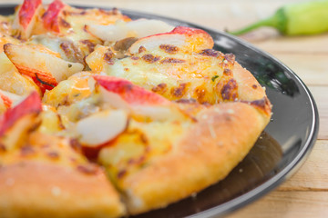 Pizza be appetizing on wooden background.