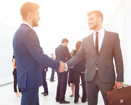 shaking hands business colleagues in the lobby of the office.