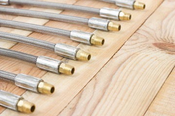 Fototapeta premium Hydraulic hoses. lines flexible object for industry on wooden background.