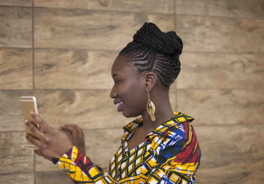 Braided woman checking her phone