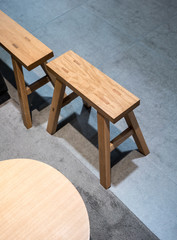 Modern wooden chairs design on concrete floor.