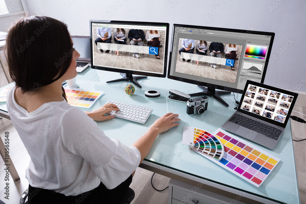 Poster Female Designer Working On Multiple Computer