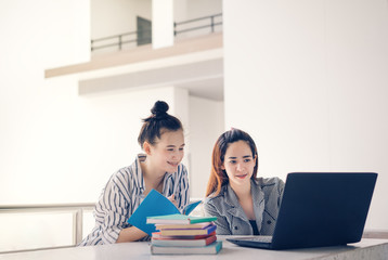 Student women teamwork together working study online or homework with laptop computer and meeting in university campus indoor