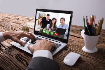 Businessperson Video Conferencing With Colleague On Laptop