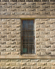 a barred window in a vintage wall in Gruene Texas