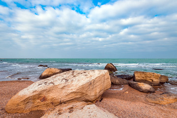 Fototapeta na wymiar Seashore with rocks and clear turquoise water