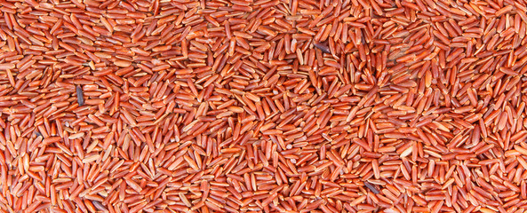 Heap of red rice as background, healthy, gluten free nutrition concept, copy space for text