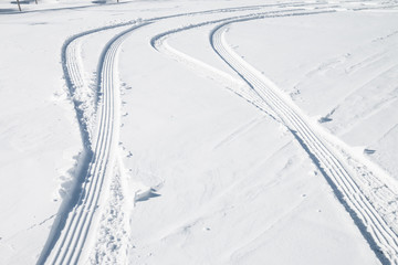 Fototapeta na wymiar Car tire track in snow