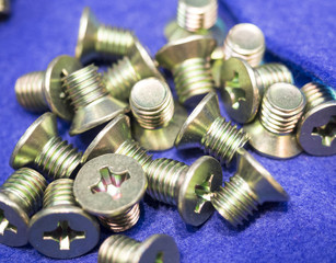 screw on blue background. Industirial screw and bolt manyfacturing