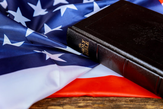 United States Flag and Bible on Distressed Wood Background