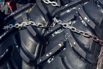 large tires with safety chains on slippery snow or ice