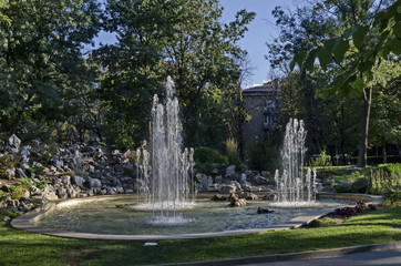 Group from small water fountains flowing in front beauty rockery, Sofia, Bulgaria  
