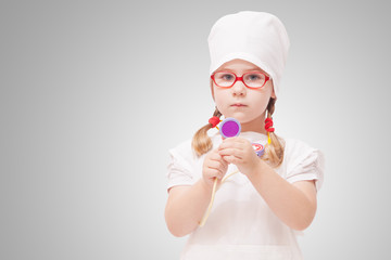 young girl with glasses plays in the doctor
