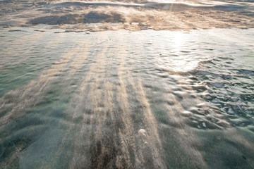 snowdrift on a frozen river during the sunset on a cold winter day