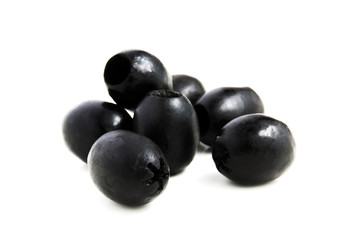 Some black olives on a white background